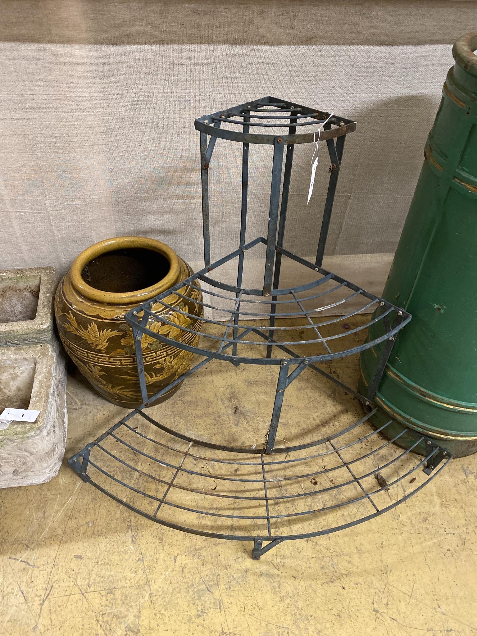A wrought iron three tier plant stand, height 75cm and a tin glazed vase